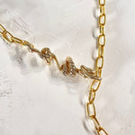 A detailed image of a gold-plated brass paper clip chain necklace with a 3D calligraphic dragon pendant on the right side, displayed on a textured white background.